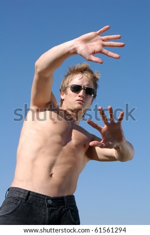 Please! No! Young shirtless man holding his hands out saying \'No\'