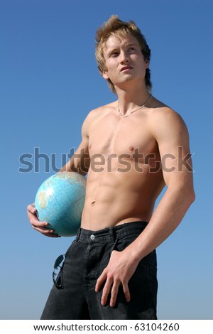 Young muscular man holding a globe