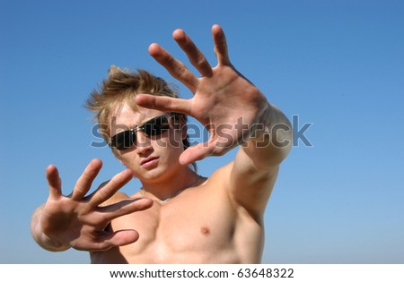 Please! No! Young shirtless man holding his hands out saying 'No'