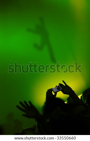 Silhouette of a man shooting the shadow of a dancer girl at some party.