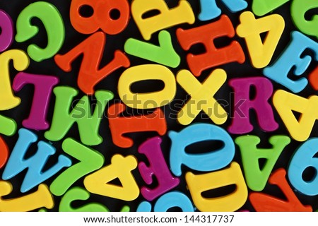 Colorful numbers and letters on black background.