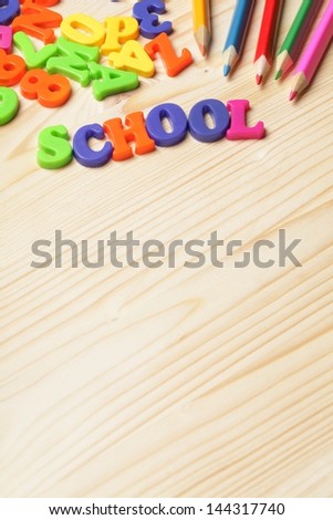 Colorful numbers and letters on wooden background