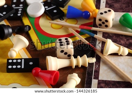 Detail of board games, pawns, chessmen, dominoes, mikado sticks and dices