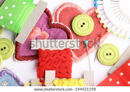 Top view of sewing items on white background.