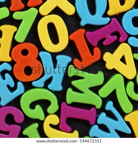 Colorful numbers and letters on black background.