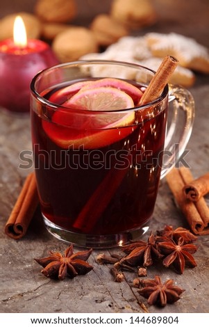 Close-up of mug with mulled wine and gingerbread cookies.