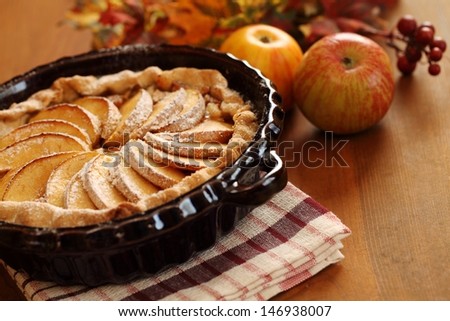 Arrangement of home-made apple pie and apples