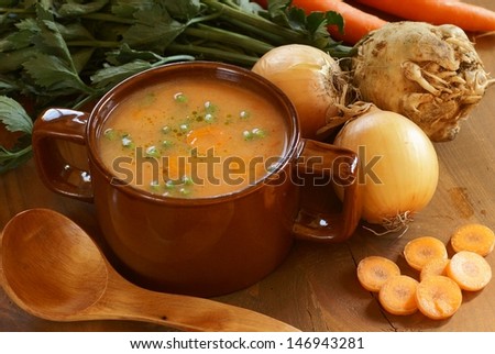 Detail of vegetable soup in pot and fresh food ingredients