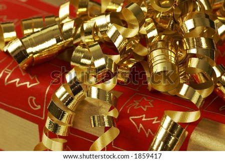 Close-up of christmas present with gold ribbon