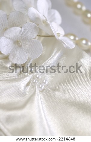 Close-up of bridal gloves and yellow wedding decorations - white flowers
