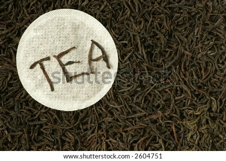 Close-up of natural black tea and round tea bag