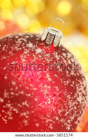 Red christmas ornament and shiny golden decorations - focus on ornaments, shallow DOF