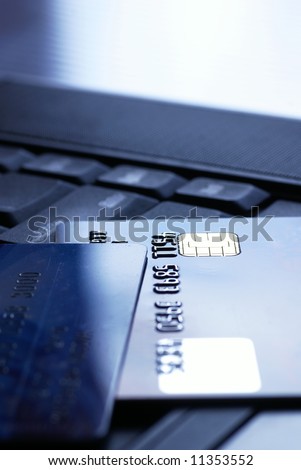 Detail of credit cards on notebook. Focus on card, shallow DOF