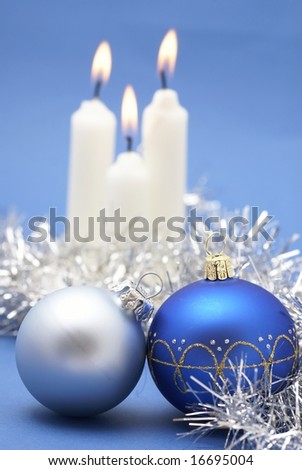 Christmas ornaments and candles on a blue background