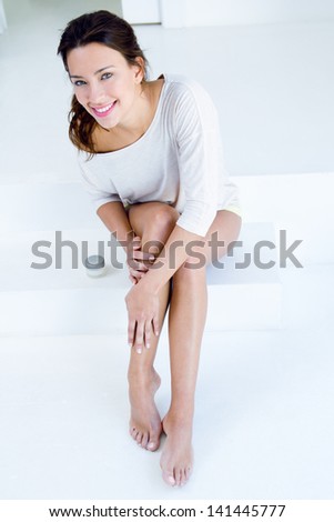 Body care Woman applying cream on legs Body care Woman applying cream on legs