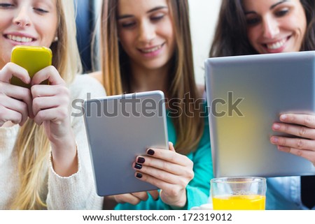 A group of friends surfing the net with smartphones and digital tablets