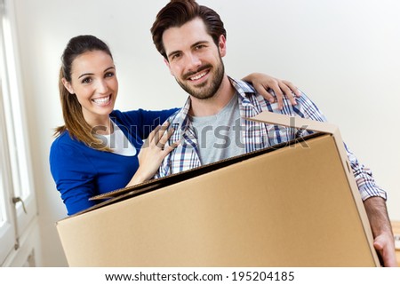 Portrait of Young couple moving in new home Portrait of Young couple moving in new home
