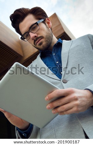 Portrait of urban business man with laptop outside in airport