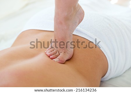 Portrait of masseur doing massage on man body in the spa salon.