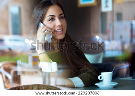 Portrait of beautiful girl using her mobile phone in cafe Portrait of beautiful girl using her mobile phone in cafe