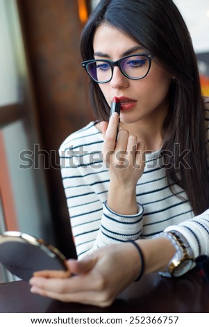 Portrait of young beautiful woman making up her face.