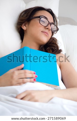 Portrait of beautiful young woman sleeping after read a book.