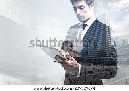Double exposure portrait of young Businessman Using Digital Tablet