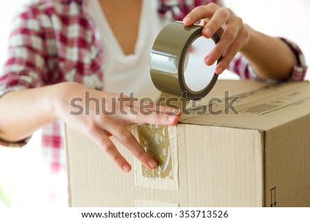 Portrait of young beautiful woman moving in a new home.