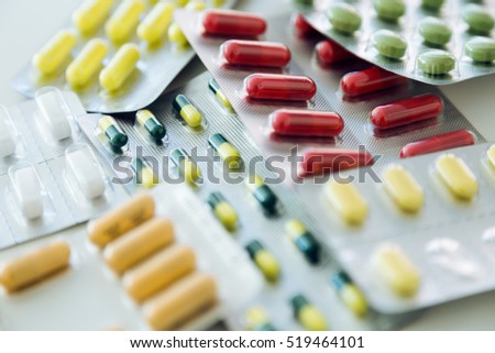 Portrait of assorted pharmaceutical medicine pills, tablets and capsules on the table.