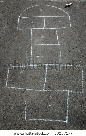 Hopscotch game outline drawn in chalk on driveway