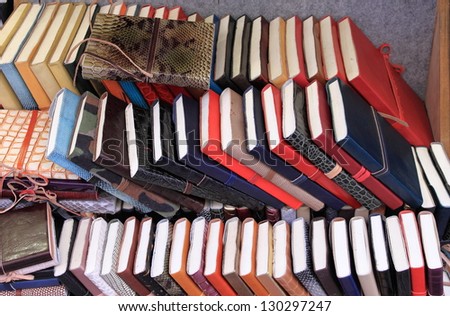 Piles of vintage books on a shelf