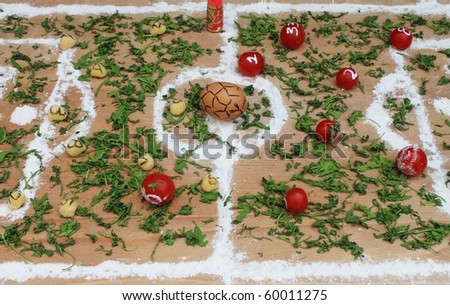 Pasta vs Tomatoes, a soccer field made with italian food ingredients