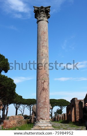 Red marble corinthian column in Ostia Antica, the old Harbour of Rome, Italy