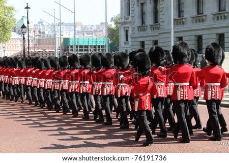 LONDON - MAY 21: The Royal Guards march toward Buckingham Palace for the guard change on May 21, 2010 in London, UK