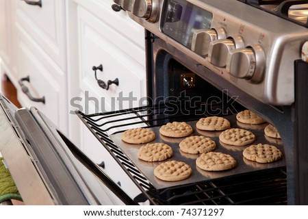 Tray of cookies coming out of the oven