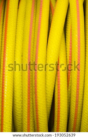 Yellow and orange water hose for watering gardens