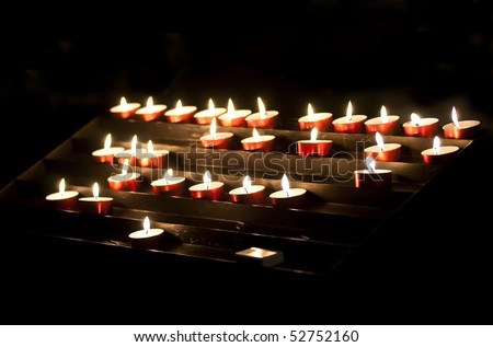 Group of votive candles in a worship place