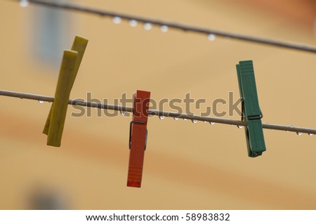 clothes-pegs of different colours under the rain