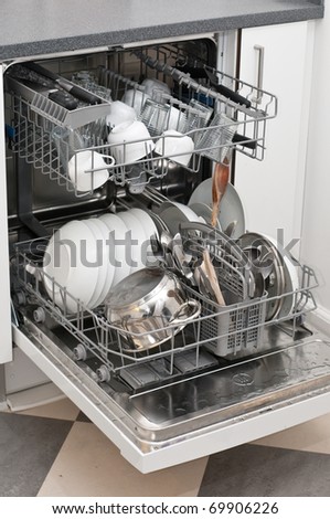 Dish washer with dirty dishes and kitchenware