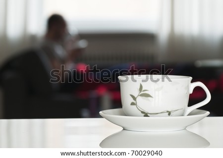 tea cup for relax time with blurred person in background