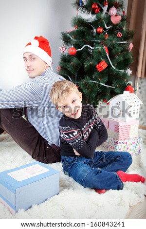 Man with son, Happy man and his son near decorated firtree
