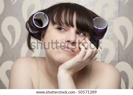 young adult girl with hair rollers  upset