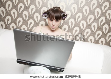 young adult girl with hair rollers with laptop