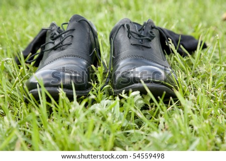 business shoes with socks on grass shallow DOF