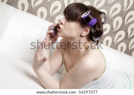 young adult girl with hair rollers speak mobile phone