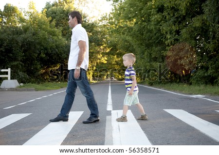 father with his son cross crosswalk
