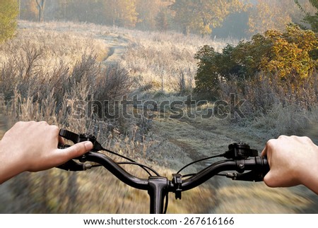Bike riding on a dirt road. The view from the driver\'s side. First person view.