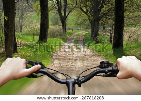 Bike riding on a dirt road. The view from the driver's side. First person view.