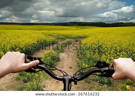 Bike riding on a dirt road. The view from the driver\'s side. First person view.