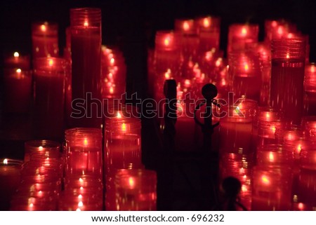 Red candles of prayer at the Barcelona, La Seu Cathedral, Spain